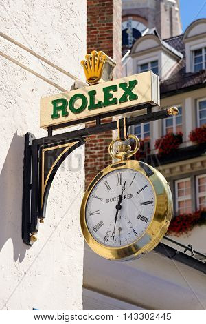 MUNICH GERMANY - AUGUST 3 2015: The logo of the brand Rolex. It was founded in London UK in 1905 and moved its base of operations to Geneva Switzerland in 1919.