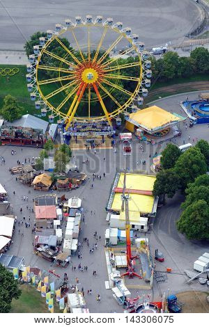 MUNICH GERMANY - 4 AUGUST 2015: Ferris Wheel in a fun fair on the grounds of the Olimpiapark near Olympia Tower.