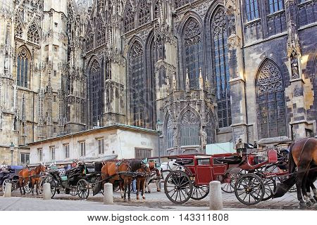VIENNA, AUSTRIA - August 27, 2015: horse-drawn carriage or fiaker, popular tourist attraction, near St. Stephen's Cathedral, symbol of the city of Vienna