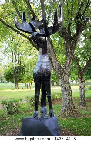 MOSCOW - SEP 22, 2015: Slender elk sculpture made of iron in city garden in VDNH