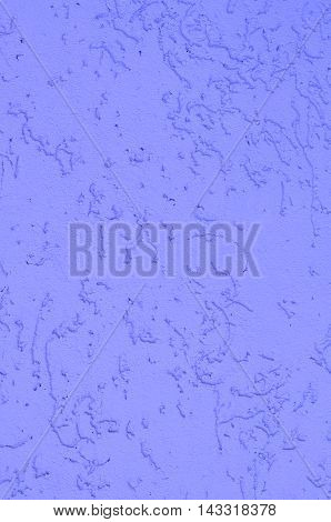 Background of a purple stucco coated and painted exterior rough cast of cement and concrete wall texture decorative coating