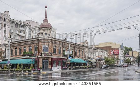 Rostov-on-Don Russia -August 142016: Historic building on the corner of Bolshaya Sadovaya Street and Kirov Prospect. At the prospect of Kirov moving cars