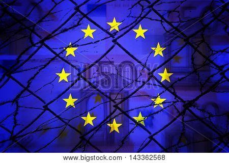 Euros, fence, EU flag and cracks - Finance/Business concept