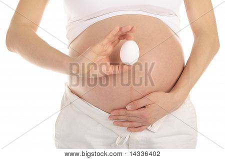 pregnant woman holding an egg
