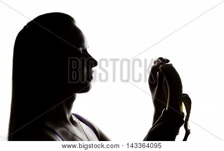Young amazed woman in lacy lingerie holding a banana, she is going to eat a banana. she sucks a banana.