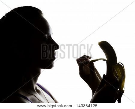 Young amazed woman in lacy lingerie holding a banana, she is going to eat a banana. she sucks a banana.