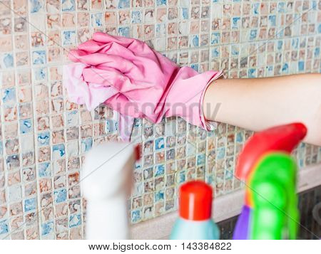 Hand In Glove Washes Ceramic Tiles On Kitchen Wall
