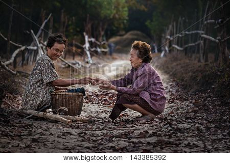 Asian old woman in the forest .