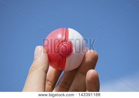 Thailand - August 20, 2016: Poke ball in Hand  (Pokemon Ball). Pokeball toy of the game Pokemon Go at Chon Buri, Thailand.