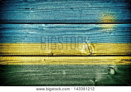 flag of Rwanda painted on old grungy wooden background: 3d illustration