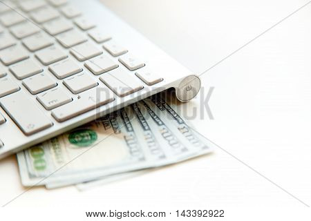 Concept image of finance and investment. 100 US dollars bank notes and money coins. with computer keyboard.