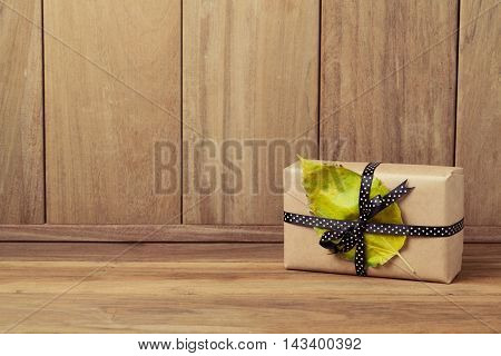 Gift box with autumn leaf. Thanksgiving holiday concept
