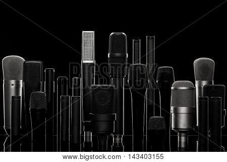 Set of different microphones against black background
