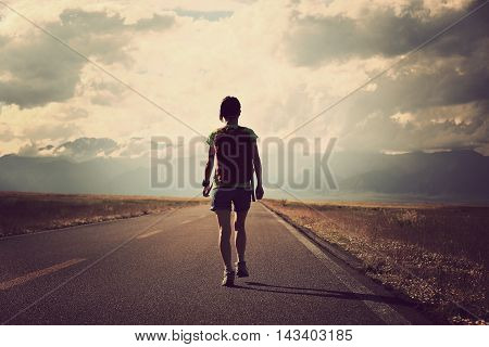 young woman hiker hiking at beautiful mountain trail