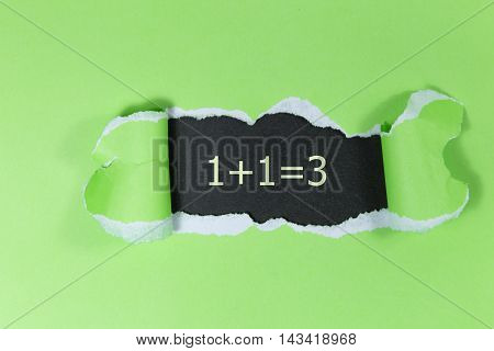 1+1=3 written under torn green paper.Business, technology, internet concept.