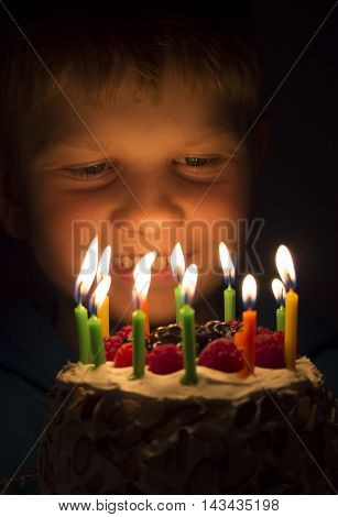 a child looking at a birthday cake
