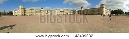 broad view of the cobblestone square with a yellow Palace