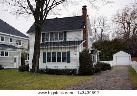 WEQUETONSING, MICHIGAN / UNITED STATES - DECEMBER 22, 2015: A white home on Pennsylvania Avenue in Wequetonsing, Michigan.