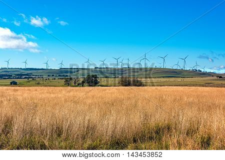 Windmill electricity turbine with rural outback background. Farmland and wind turbines. Myrtleville NSW Australia