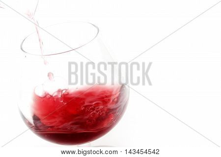 abstract patterns pours a drink into a glass of wine