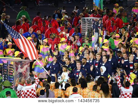RIO DE JANEIRO, BRAZIL - AUGUST 5, 2016: Olympic champion Michael Phelps carrying the United States flag leading the Olympic team USA in the Rio 2016 Opening Ceremony at Maracana Stadium