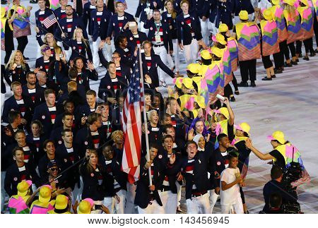 RIO DE JANEIRO, BRAZIL - AUGUST 5, 2016: Olympic champion Michael Phelps carrying the United States flag leading the Olympic team USA in the Rio 2016 Opening Ceremony at Maracana Stadium