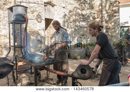 Demonstration By Two Blacksmiths Labor Metal To The Old Way
