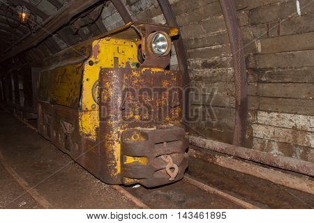 Mine railway in undergroud. Modern coal mine . Real underground post mine illuminated tunnel .