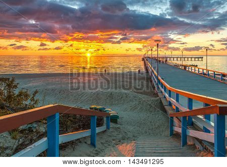 Colorful sunset at a famous marine pier in the Baltic resort city of Palanga, Lithuania, Europe