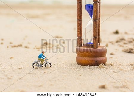 Image Of Mini Figure Dolls Biker And Sandglass On The Beach
