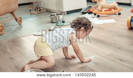 Young pregnant mother and her little daughter, at home