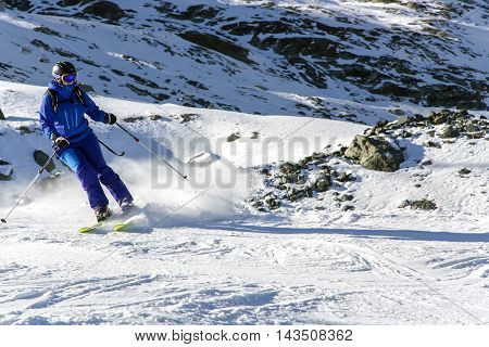 SWITZERLAND, SAAS-FEE, DECEMBER, 26, 2015 - Skier on snowy slope Felskinn snow sports routes with natural snow. Varied routes for freeriders and snowboarders at an altitude of 2550 m near Saas-Fee, Switzerland.