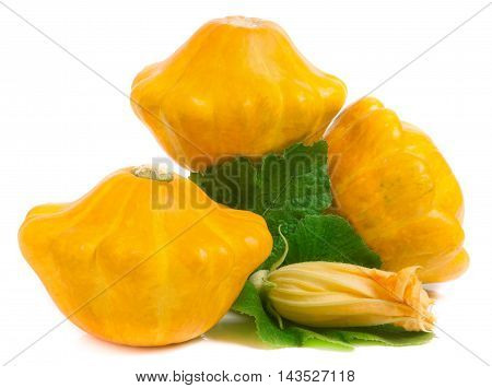 three yellow pattypan squash with leaf and flower isolated on white background.