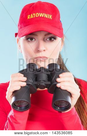 Lifeguard On Duty Supervising With Binoculars.