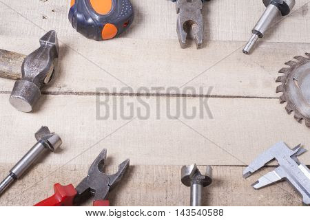 Construction tools on wooden background. Copy space for text. Set of assorted work tools at wood table . Top view.