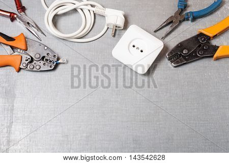 Set of electrical tool on wooden background. Accessories for engineering work, energy concept