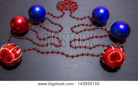 Christmas Red And Blue Balls With Bead On Black Background.