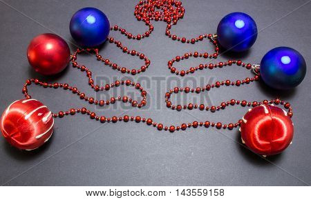 Christmas Red And Blue Balls With Bead On Black Background.