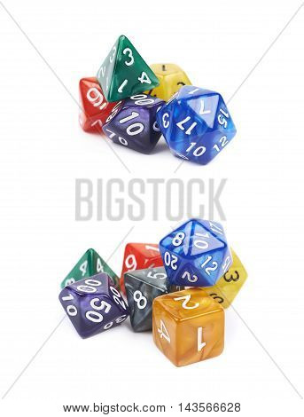 Pile of colorful roleplaying polyhedral dices isolated over the white background, set of two different foreshortenings