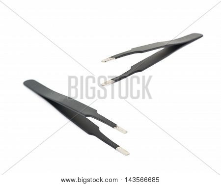 Black metal anti-static tweezers tool isolated over the white background, set of two different foreshortenings