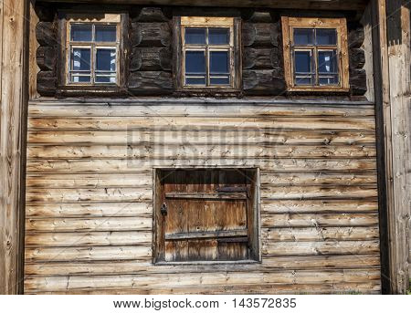 Old door and window on the wooden wall of a village house. Excellent background