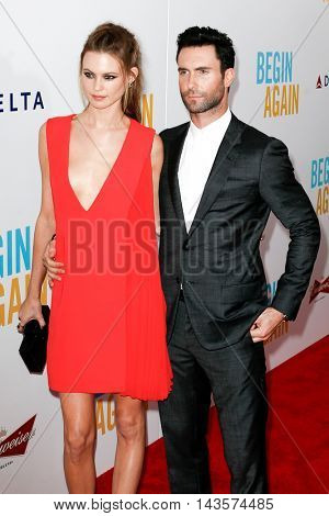 NEW YORK-JUNE 25: Behati Prinsloo (L) and Adam Levine attend the New York premiere of 