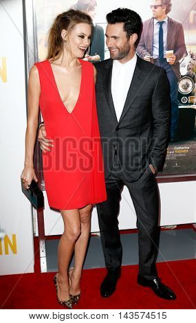 NEW YORK-JUNE 25: Behati Prinsloo (L) and Adam Levine attend the New York premiere of 