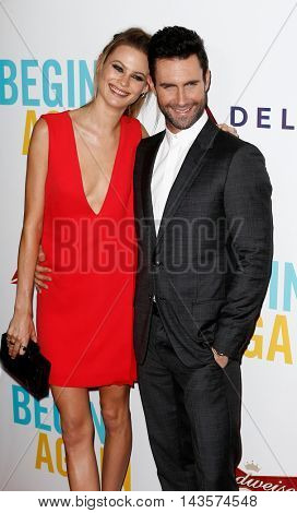 NEW YORK-JUNE 25: Behati Prinsloo (L) and Adam Levine attend the New York premiere of 