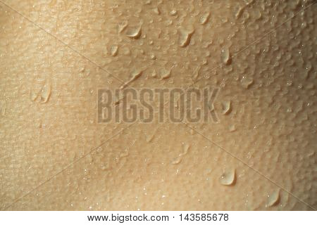 Wet skin human texture with water drops closeup background