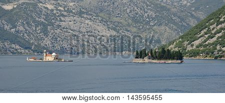 The islands of Our Lady of the Rock on the left and St George's Abbey on the right in Kotor Bay Montenegro. The former was artificially created by locals using rocks the later is also known as the Island of the Dead and contains a 12th century Benedictine