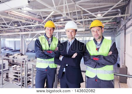 Team of manager and two workers in CNC factory