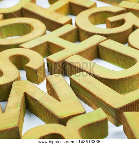 Surface coated with the multiple painted wooden block letters as an abstract backrop composition