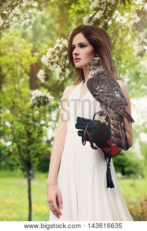 Fashion Model Woman Wearing White Dress with Bird Outdoors