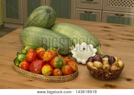 zucchini squash tomatoes and cucumbers on the table in the kitchen in the countryside